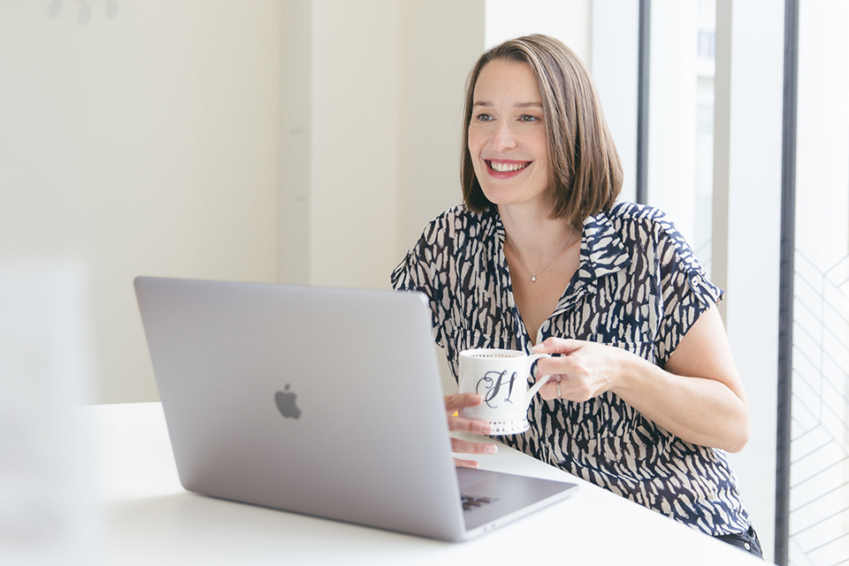 Hazel having a cup of tea sitting at her computer